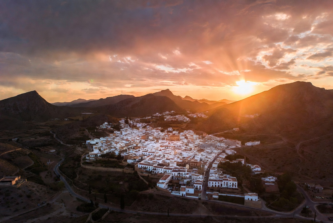 Panoramic view of Alhama de Almería, white village nestled in golden Andalusian mountains